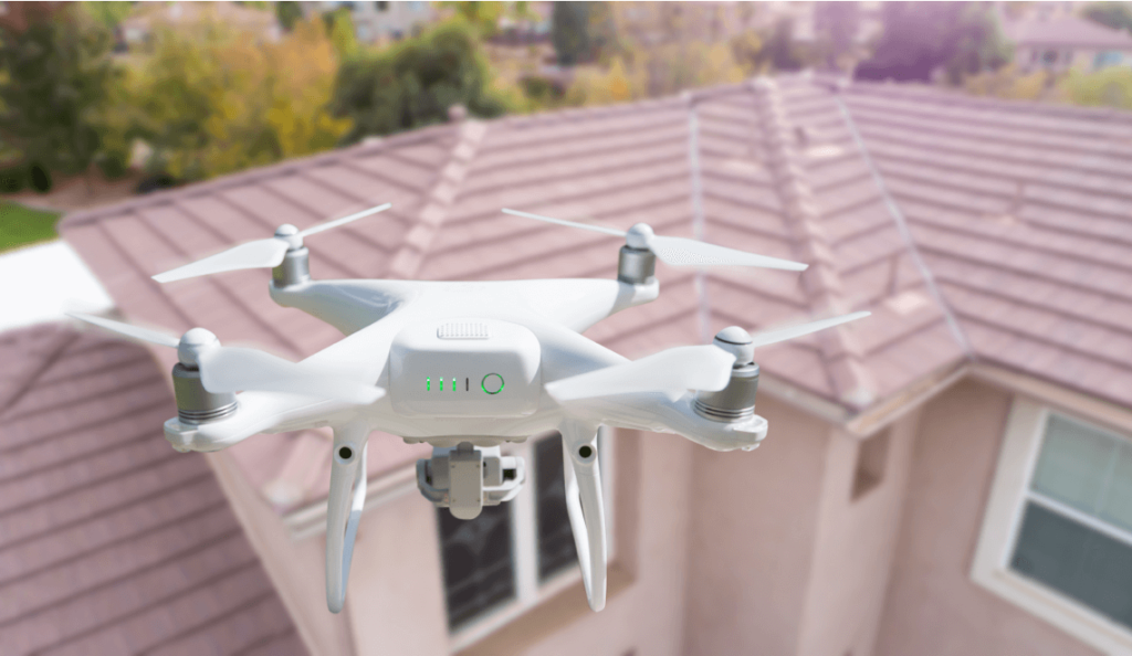 Drone conducting roof inspection to identify moisture intrusion and mould risk areas on residential property